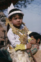 Very young boy at novice monk initiation ceremony.Burma Myanmar