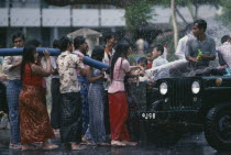 Buddhist Water Festival.  Crowds spraying water from hose. Burma Myanmar