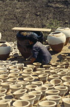 Woman worker in pot making centre.Burma Myanmar Center