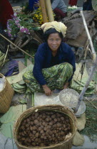 Woman selling rice cakes at street market near Inle Lake.Burma Rangoon Myanmar Yangon