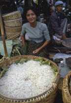 Young woman selling noodles on market stall near Inle Lake.Burma Myanmar