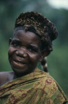 Pygmy woman wearing civet skin hat.  Portrait.Former Zaire
