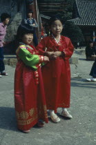 Children wearing national dress at Buddhist temple.