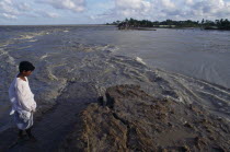 Water gushing in and out of breach in main coastal embankment  errosion