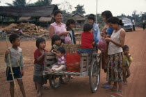 Local women and children with handcart on the road to Nam Ngon Dam