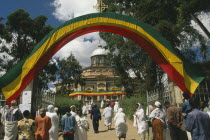 St George Church  Kidus Giorgis  the principle church in Addis Ababa.  People entering grounds under archway draped in the colours of the national flag to attend ceremony.Orthodox