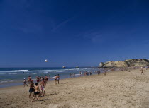 View along beach with children playing beach football.soccer