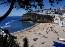 Portugal, Algarve, Carvoeiro, View over the fishing cove beach with clifftop housing beyond.