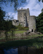 Blarney Castle  view of grey stone castle with garden in front