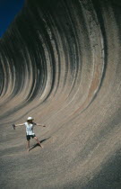 Tourist pretending to ride the waves like a surfer