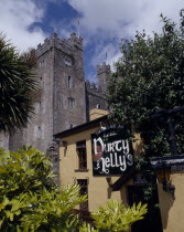 Durty Nellys Pub  bushes  trees  castle behind with flags