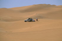 Tourists four by four vehicle stuck in Saharan sand.