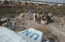 UN peacekeeping team installing water pump and well in refugee camp for people displaced by civil war. United Nations