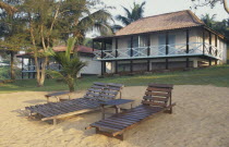 Guest chalets at the Hotel Balmer with wooden sun loungers in foreground.Cte d Ivoire