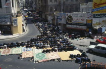 Crowds attend Friday prayers in the street. Moslem