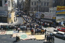 Crowds attend Friday prayers in the street. Moslem