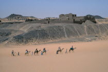 Monastery of St Simeon.  Deserted monastery on the west bank of the River Nile built in the 7th centuary AD.  Passing tourist camel train in foreground.