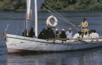 Felucca sailboat full of passengers on the River Nile.