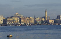 City on coast where the Suez Canal meets the Mediterranean and founded in 1859 to house canal workers.  City and Suez Canal at dusk.