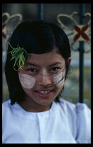 Portrait of young girl with sandlewood paste on her cheeks and nose used as a beauty enhancer.Burma Rangoon