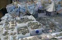 Stall with many different types of Brazilian coins and notes which have changed frequently. Brasil