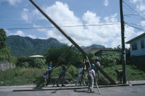 Workers raising new telegraph pole.