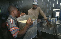 Men working in maize mill in camp for Angolan refugees.
