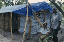 Elderly couple beside shelter in camp for Angolan refugees.
