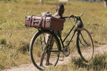 Young boy with bicycle.