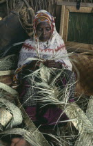 Somali woman making basket from woven fibres in Dadaab refugee camp.East Africa