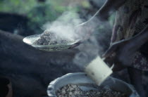 Cropped view of woman holding plate of cooked beans  the staple diet of the Kambas  Bantu people who live in the semi-arid eastern province.East Africa