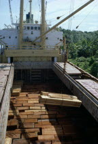 Timber being loaded onto ship for export. Brasil