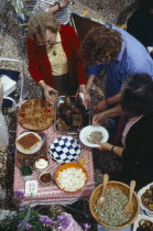 Women serving traditional meal for Feast of the Spitted Lamb held on Easter Day.