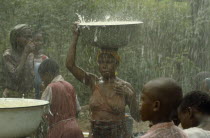 Women during wet season harvesting rainwater as part of UNICEF project
