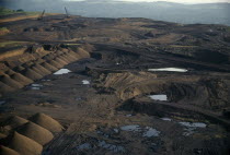 Aerial view over manganese mine and devastated landscape.