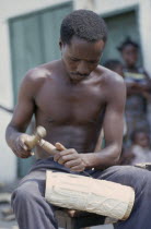 Man carving piece of ivory. Zaire