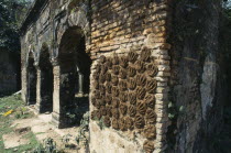 Drying cakes of cow dung on wall of old building for use as fuel.Alternative energy