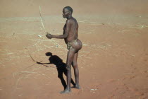 Bushman hunting with bow and arrow.