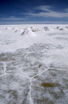 Salt flats with salt shovelled in to piles awaiting collection