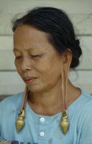 Long Lama woman wearing heavy earrings in stretched ear lobes