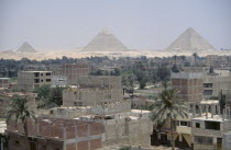 City suburbs encroaching on the Pyramids at Giza.