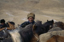 Kazakh nomads on horseback gather for Kazakh New Year horse race
