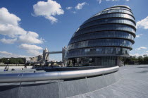 City Hall  exterior view of the curved architecture with Tower Bridge in the distance