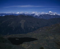 View from above towards mountain peak of Jitchu Drakey 6989 metres above sea level  in drifting cloud.