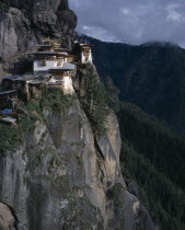 View of monastery situated high on cliff face.