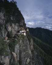 View of monastery situated high on cliff face.