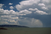 Two gers or yurts in departing storm rain falling