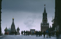 Red Square in winter with crowds and spires of St Basils Cathedral and clock tower