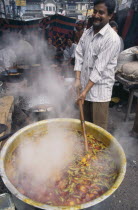 Cooking Potato curry in the street.