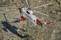 Air Sea Helicopter Rescue hovering over rocks